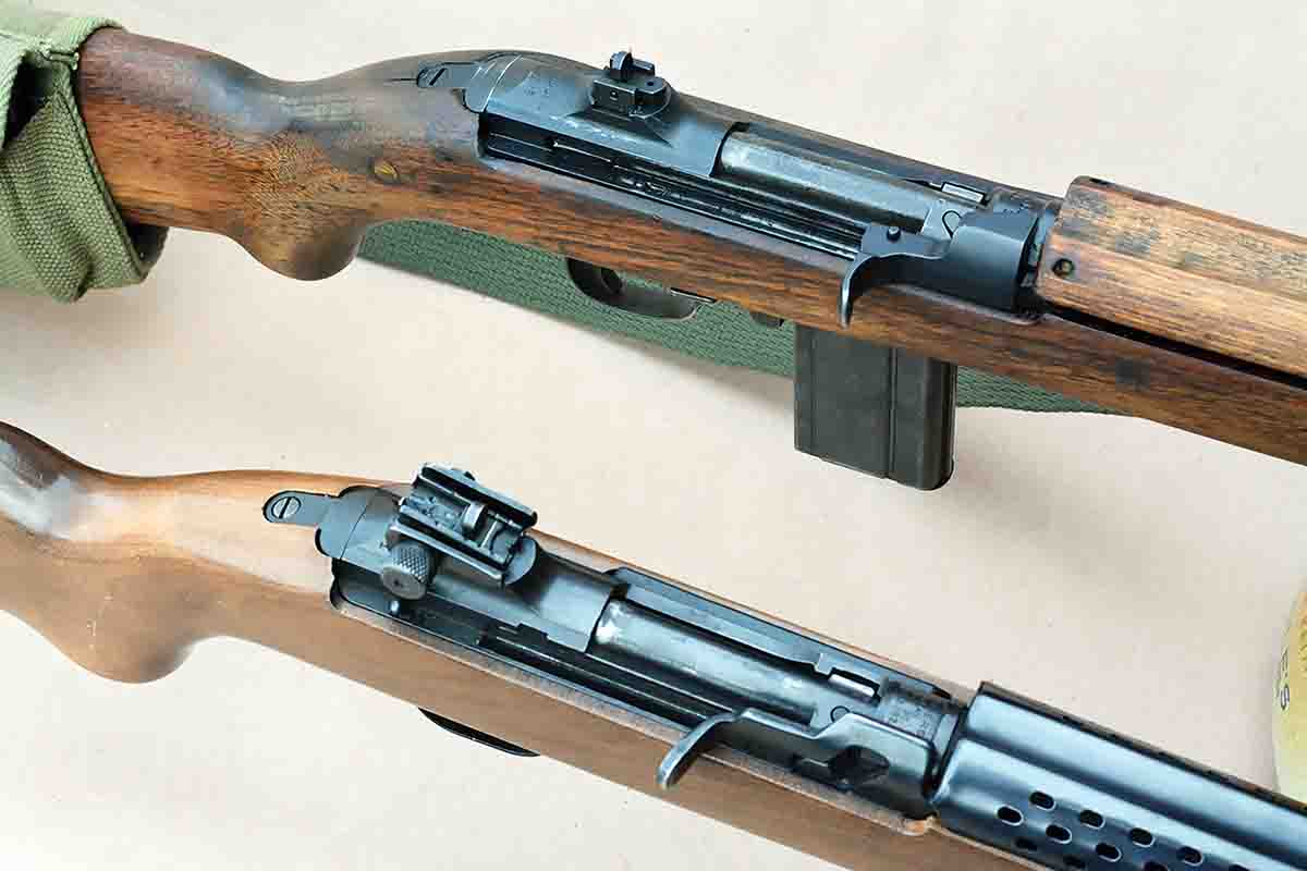 The Universal Firearms Model 1001 Military chambered in 30 Carbine (bottom) is similar in design to the original U.S. M1  Carbine (top), but there are distinct changes in the design.